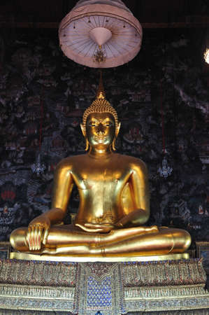 Golden sitting Buddha statue in temple in thailand のeditorial素材