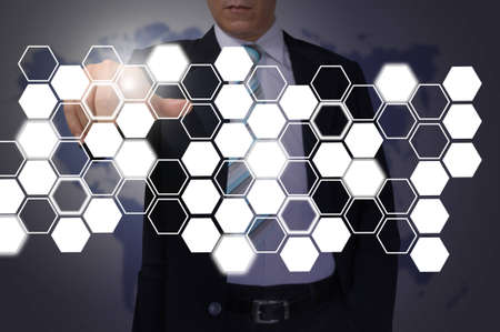 Hand of Business Man Pressing or Pushing hexagon button on touch screen interfaceの写真素材