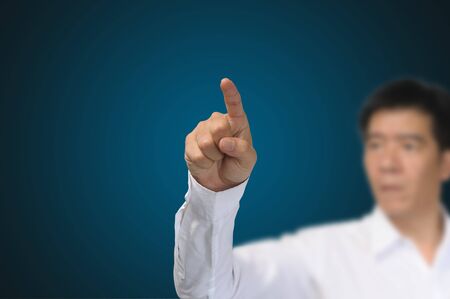 Business Man Pointing on gradient blue backgroundの写真素材