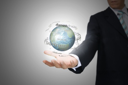 Hand of Business Man Hold Earth Globe surround by Business wordの写真素材