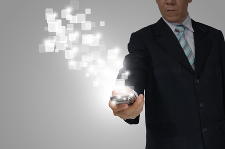 Hand of Business Man Hold touch screen of smartphone sending digital data.の写真素材