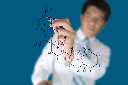 Male Teacher write science formula on blue backgroundの写真素材