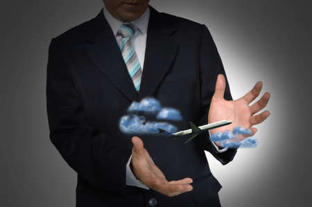 Airplane in the hand of business manの写真素材