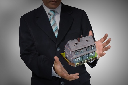 Business Man holding house or homeの写真素材