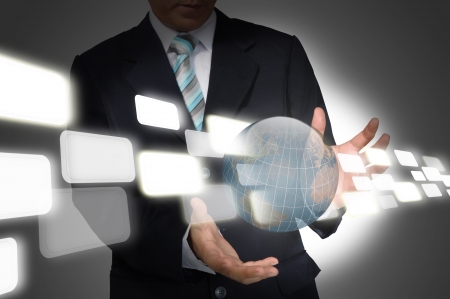Business Man holding earth globe and flying data   Elements of this image furnished by NASA の写真素材