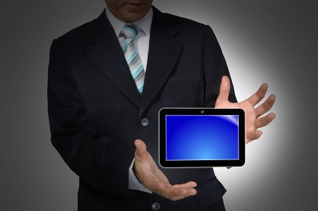 Hand of business Man holding Touch screen tablet PCの写真素材