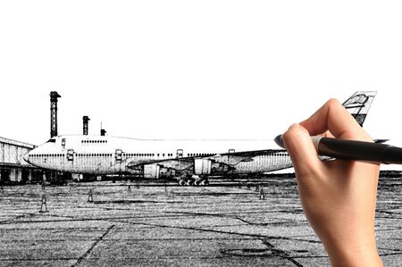 Male Hand drawing airplane at the airportの写真素材