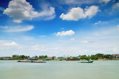Boat in the river of Chaopraya under the blue sky in Bangkok, Thailand の写真素材