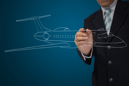 Business Male Hand drawing airplaneの写真素材