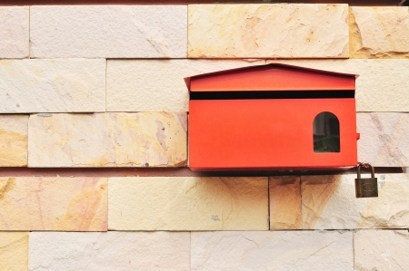 Red Postbox on wall of Sandstoneの写真素材