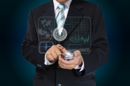 Hand of Business man touch smart phone with virtual digital interface or environmentの写真素材