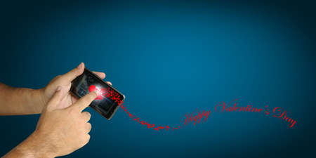 Hand of Business man hold smartphone with Happy Valentine themeの写真素材