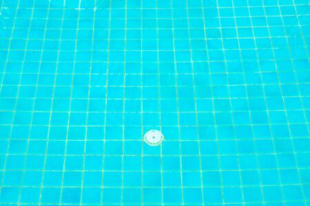 Tile under the water of Swimming pool with drain holeの写真素材