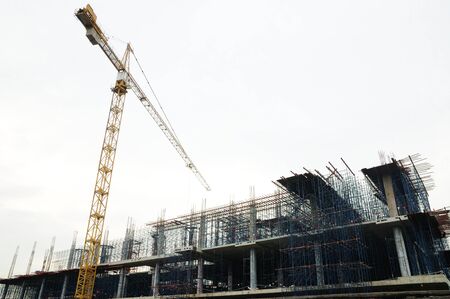 Tower crane beside construction siteの写真素材