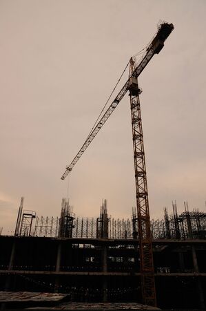 Tower crane beside construction site at the duskの写真素材