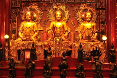 three big golden buddha chinese style of Wat Mangkon Kamalawat (Wat Leng Nei Yi) in Bangkok, Thailand.のeditorial素材