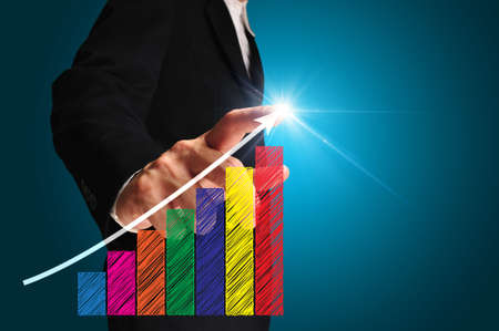 business man writing over achievement bar chart の写真素材