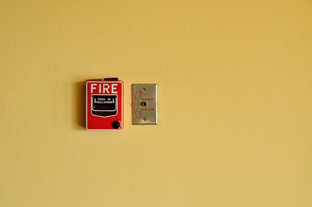 Fire Alarm on Yellow Concrete wallの写真素材