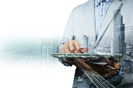 Double exposure of city and businessman on the phone as Business development concept.の写真素材