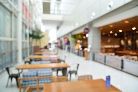 Blur Background with Bokeh of Emplty Table in Coffee shop in Modern building