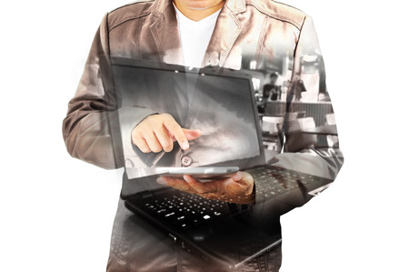Double exposure of Business Man using Mobile Tablet PC with Notebook or laptop computer as Wireless Technology concept.の写真素材