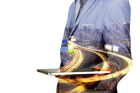 Double exposure of a businessman and a city using a tablet with City Scene and Expressway