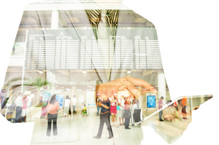 Double exposure of a businessman and a city using a tablet with Flight Schedule Boardの写真素材