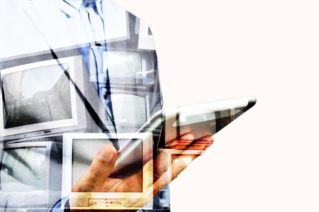 Double exposure of Business Man use Mobile Tablet with Television display as Application Technology...
