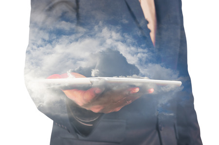 Close up of businessman with tablet and cloud double exposure isolated on whiteの写真素材