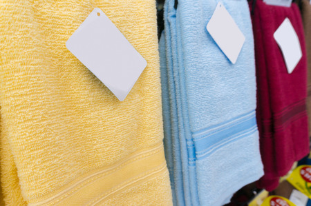 Colorful towels on supermarket shelves with Blank Tags, Shallow Depth of Fieldの写真素材