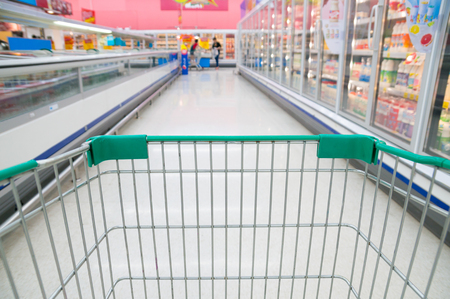 Abstract blurred photo of store with trolley in Supermarket store bokeh backgroundの写真素材