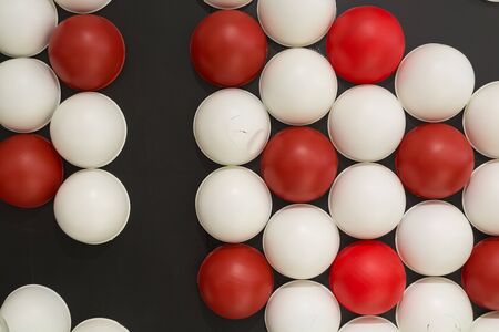Background of Red and White Sphere on Black Wall with Dramatic Lightingの写真素材