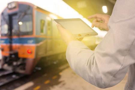 Businessman Hand use Wireless Tablet PC Device in Railway Station or Train Stationの写真素材
