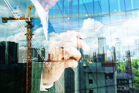 Double exposure of business engineer and abstract city as Construction industrial conceptの写真素材