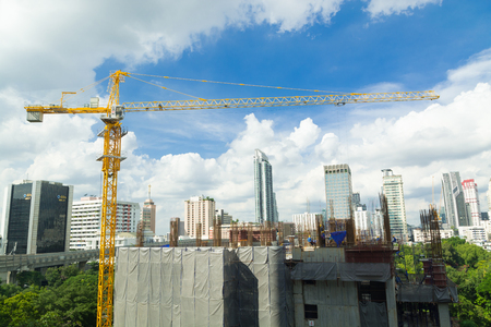 Construction Site with Tower Crane and Scenic Modern City Buildingの写真素材