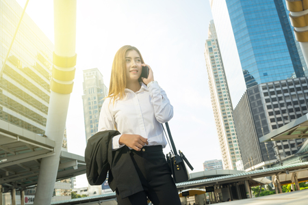 Asian Business Woman use Wireless Smartphone in Modern City as Digital Technology Conceptの写真素材
