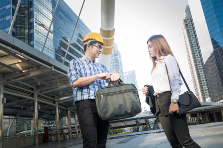 Businessman or Architect and Secretary or Assistant talking while Looking to Watch as Business Time Schedule Conceptの写真素材