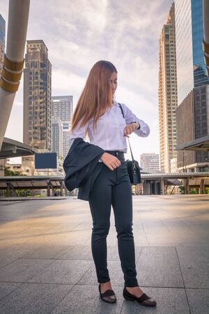 Young Business woman looking Watch as Waiting Appointment or Time Responsibility  as Business Concept.の写真素材