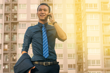 Businessman Use Digital Smartphone with Modern City Building Background as Business Technology Concept.の写真素材