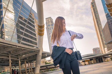 Young Business woman looking Watch as Waiting Appointment or Time Responsibility  as Business Concept.の写真素材
