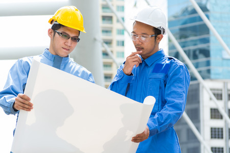 Two Engineer or Architect discuss on Modern Building Project at Construction site in Urban Cityの写真素材