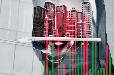 Double Exposure of Businessman use Digital Wireless Smart Touch Screen Tablet with Modern Building as Real Estate Project Development or Construction Concept.の写真素材