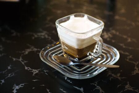 Coffee cappuccino on the table with blur background