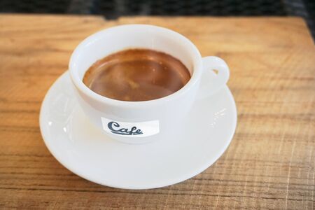 white cup of Espresso coffee on the wood textureの写真素材