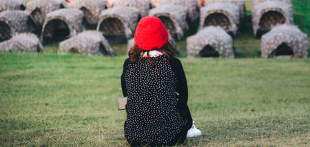 A girl sit on grass with camping background on the mountain winter seasonの写真素材