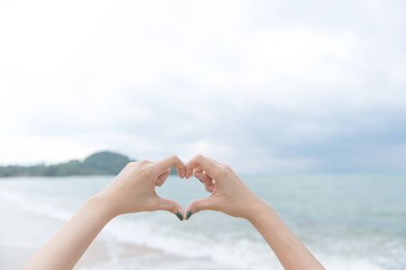 heart with hands over nature background, valentine day backgroundの写真素材