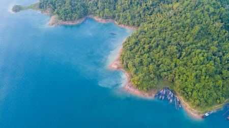 Beautiful green mointain and lake with boats in Ratchapapa dam Thailandの写真素材