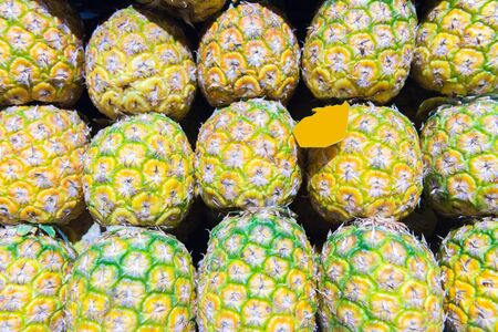 a lot of pineapples on the market as a backgroundの写真素材