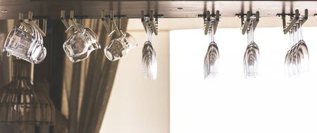 Cocktail glasses hanging over a bar