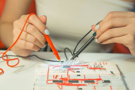 Woman with voltmeter, Woman measuring electrical currentの写真素材